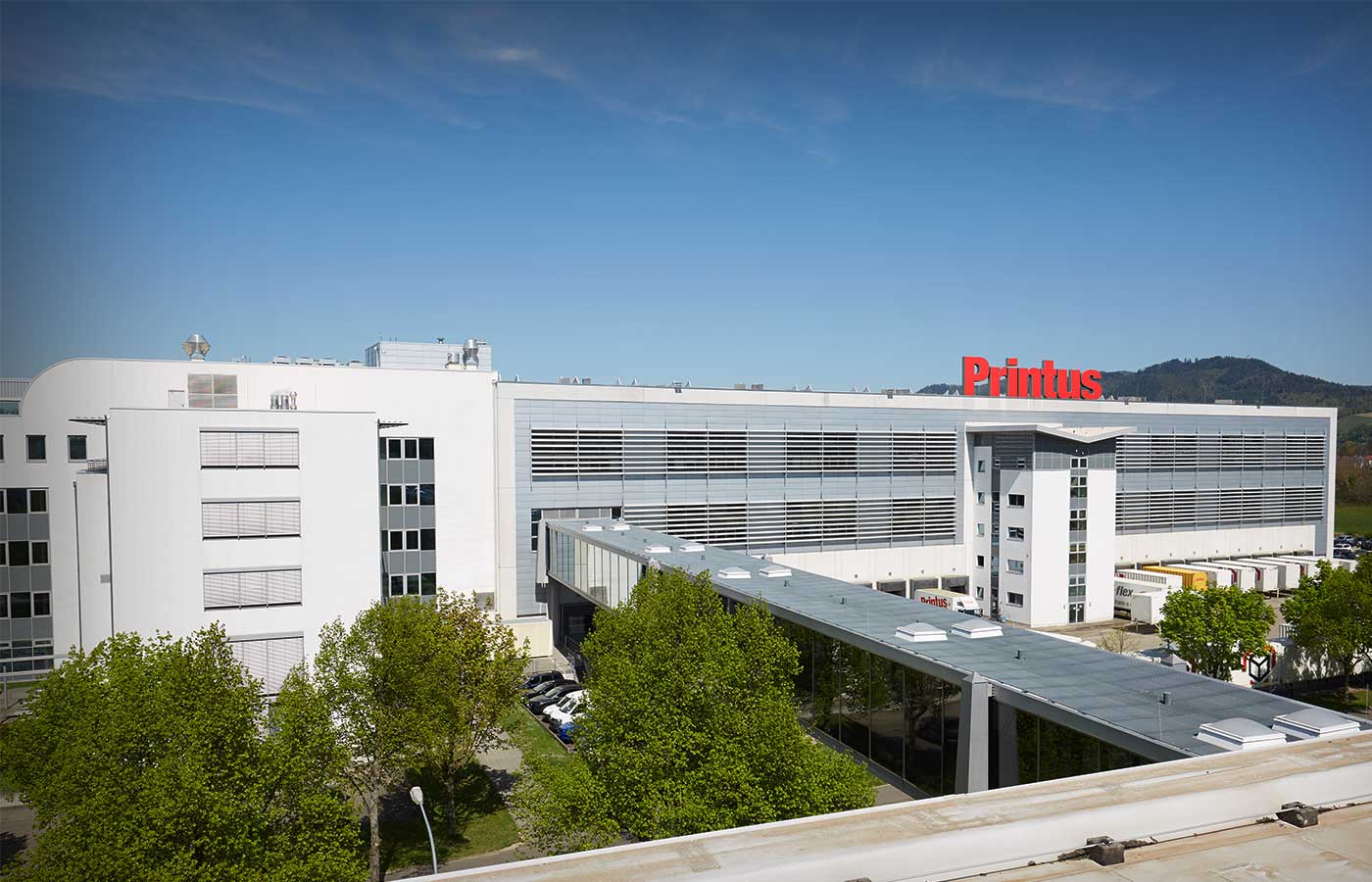 Moderne Firmenzentrale von Printus mit markanter roter Logoaufschrift auf dem Gebäude in Offenburg