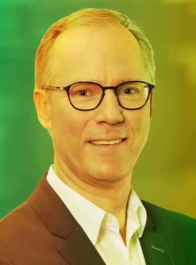 Porträt von Ralf Dieterich, Ansprechpartner bei Printus, mit farbigem Verlauf im Hintergrund ChatGPT fragen